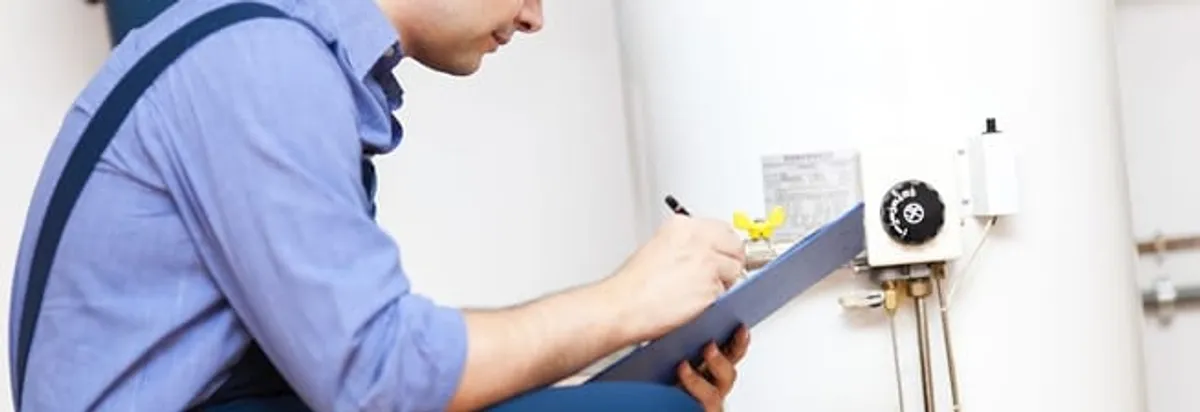 Water heater repair technician inspecting the unit and recording service notes in Saint Petersburg, FL